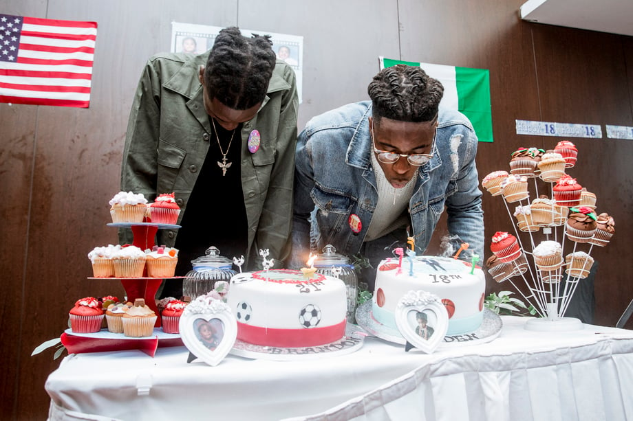 Aidan and Brandon blow out candles on cakes that mark their 18th and 21st birthdays in this photo by Johnnie Izquierdo