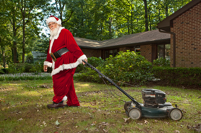 Santa Claus mowing the lawn