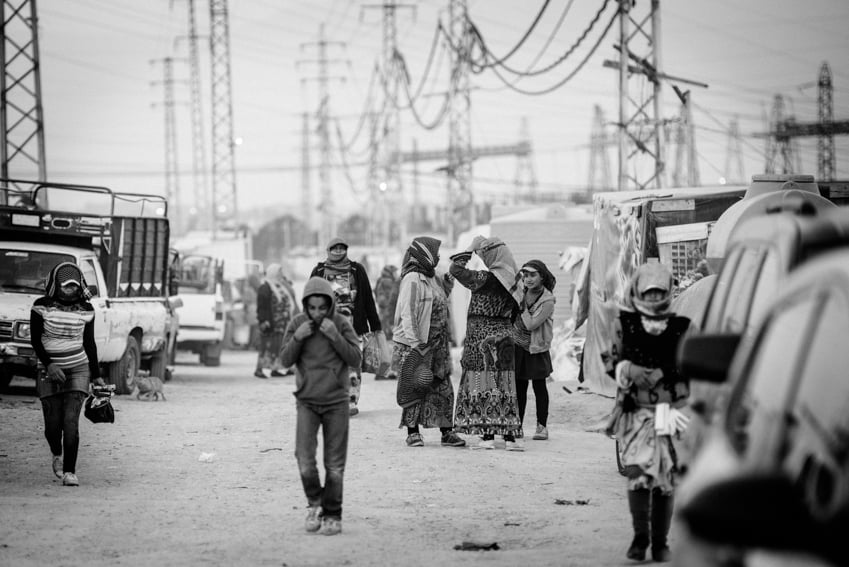 Syrian refugees in a Bekaa Valley settlement street photographed by Erol Gurian