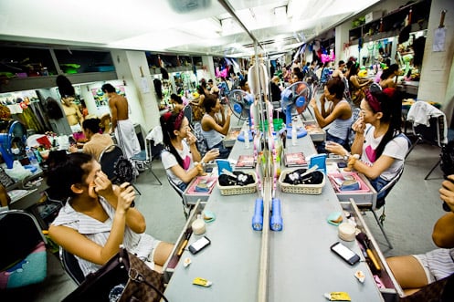 Putting on make-up in Thailand shot by Aaron Joel Santos for the Wall Street Journal