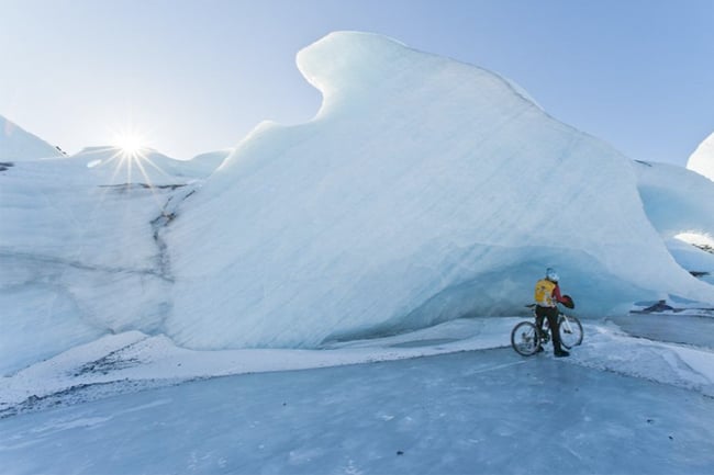 Person standing over a bike observing a glacier shot by Anchorage, Alaska-based landscape photographer Dan Bailey 