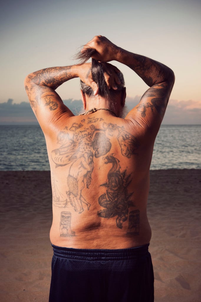 Delbert Wakinekona displays the tattoos covering his back for portrait photographer Marco Garcia