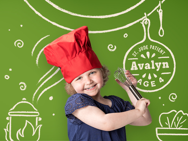 Avalyn, age 4, is shown here by Terri Glanger wearing a chef's hat and holding a whisk against a green backdrop