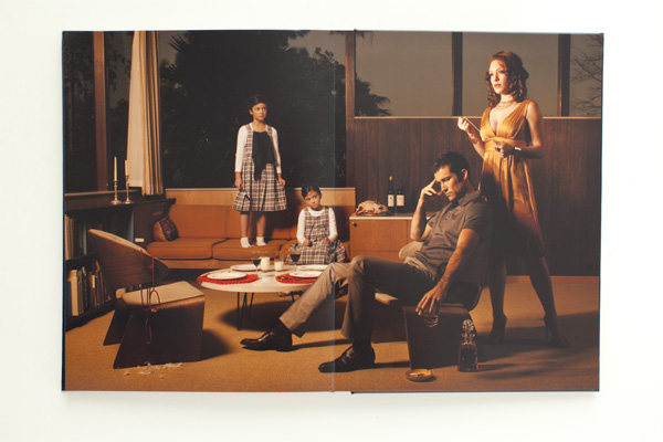 Page from photographer Stephanie Diani's print portfolio book showing a moody family portrait. 