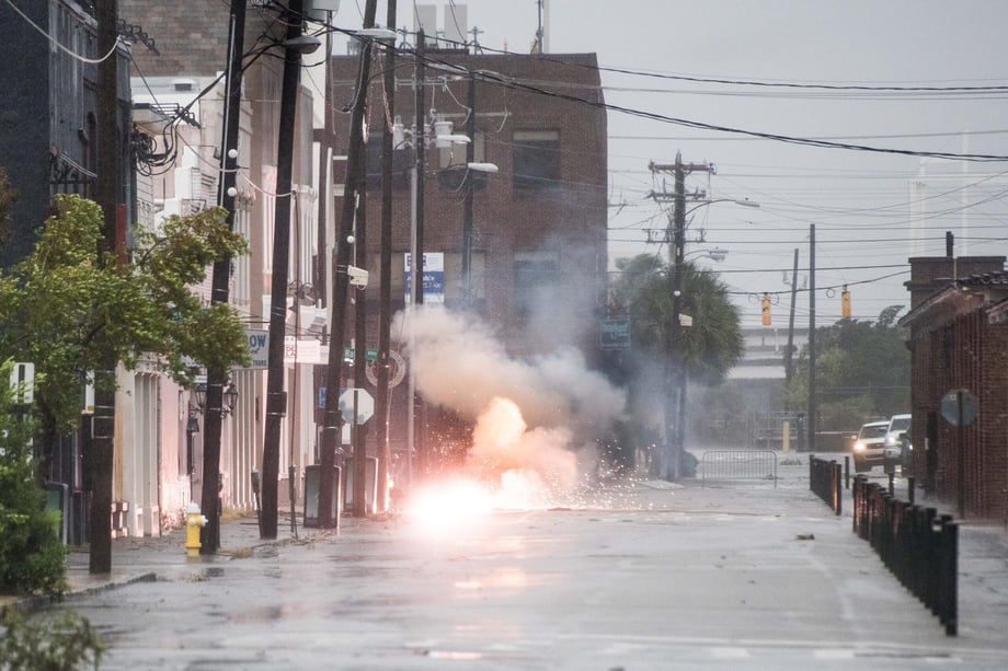Sean Rayford caputres an electrical fire sparking on a street near a row of buildings in Charleston after Hurricane Dorian