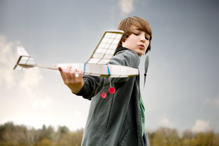 Young boy flying model airplane shot for the Washington Post by Robb Scharetg
