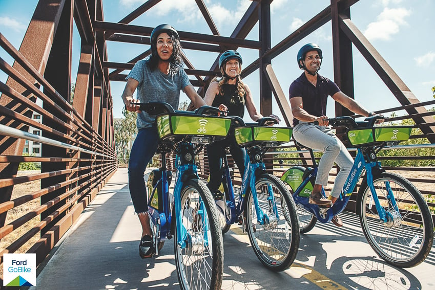 jayms ramirez shoots a photo of 3 riders using ford gobikes on a sunny day