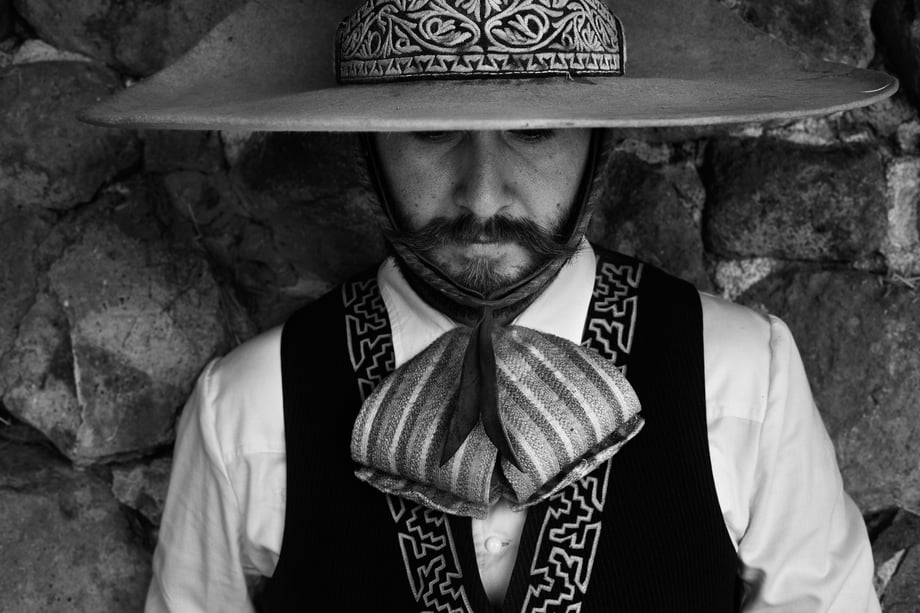 This black and white portrait by Nicole Franco shows a horseman, or Charro, in his beautifully embroidered traditional garb and hat