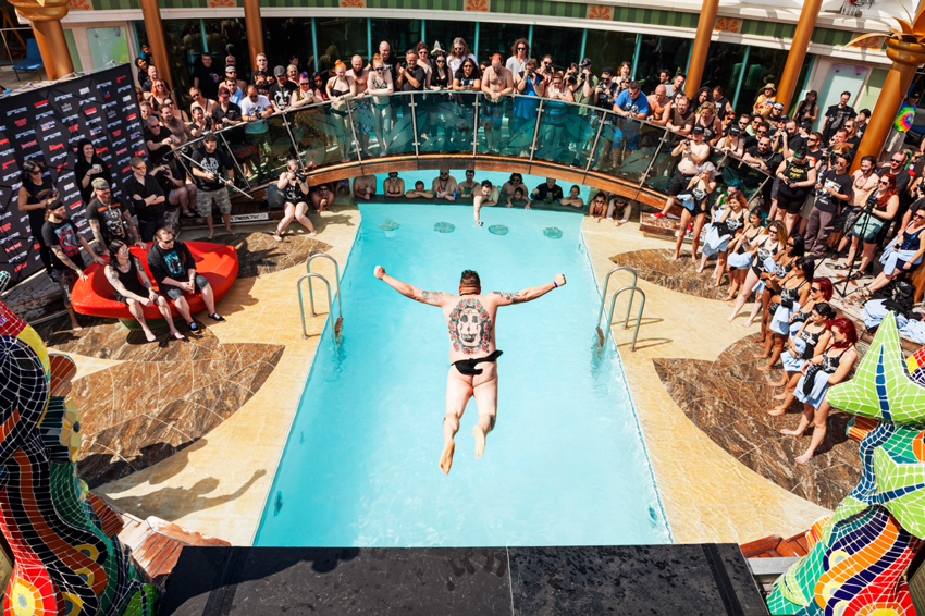 A nude, tattooed man jumps into a cruise ship swimming pool, photo by Giacomo Fortunato