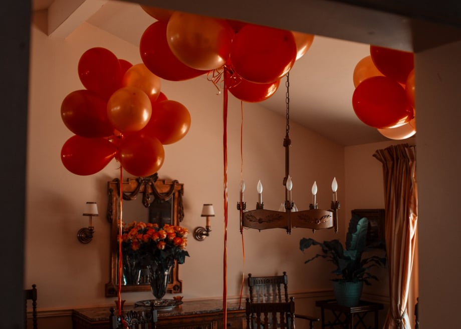 Balloons in a dining room, photograph by Rachel Hulin