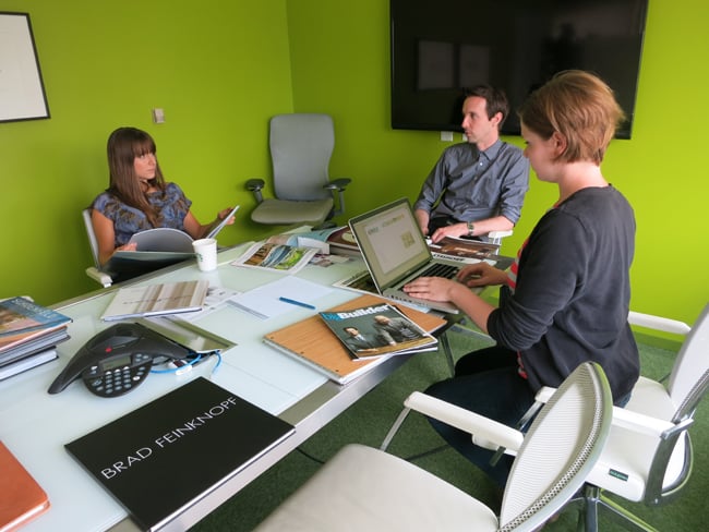 Sarah, Robb, and Elyse discussing upcoming projects while browsing portfolios
