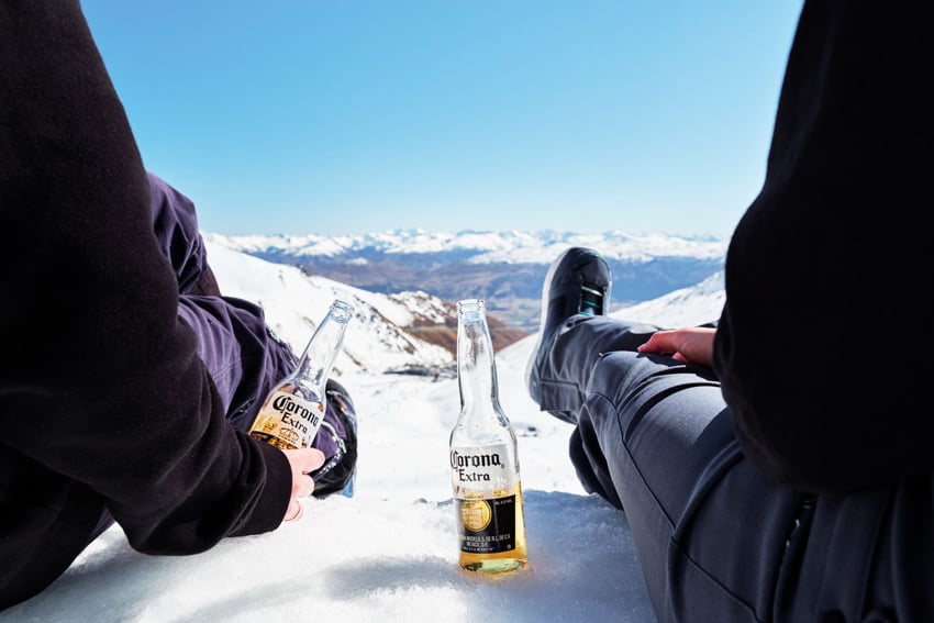 Two people drinking Corona beers at NZSki resorts photographed by Jameson Clifton