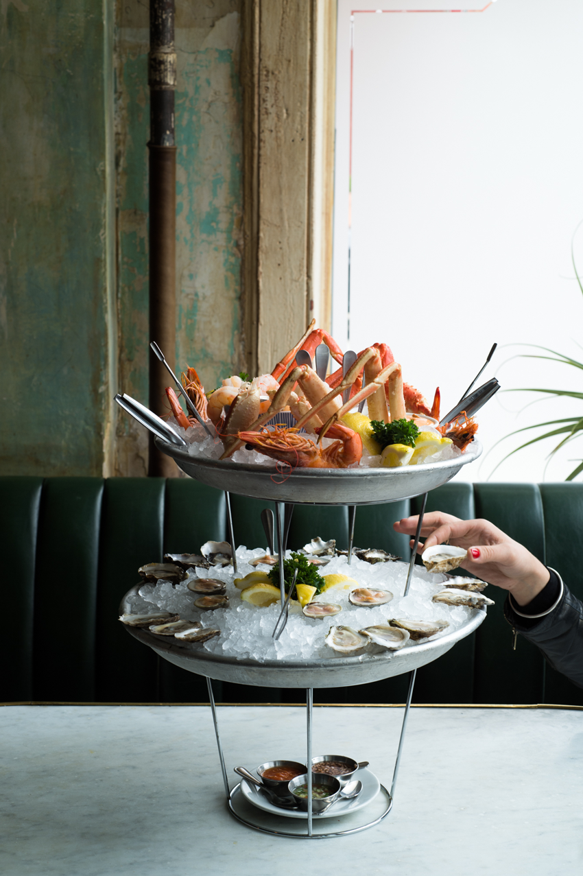 A two tiered, fresh seafood feast featuring oysters and crab, photo by Jennifer May
