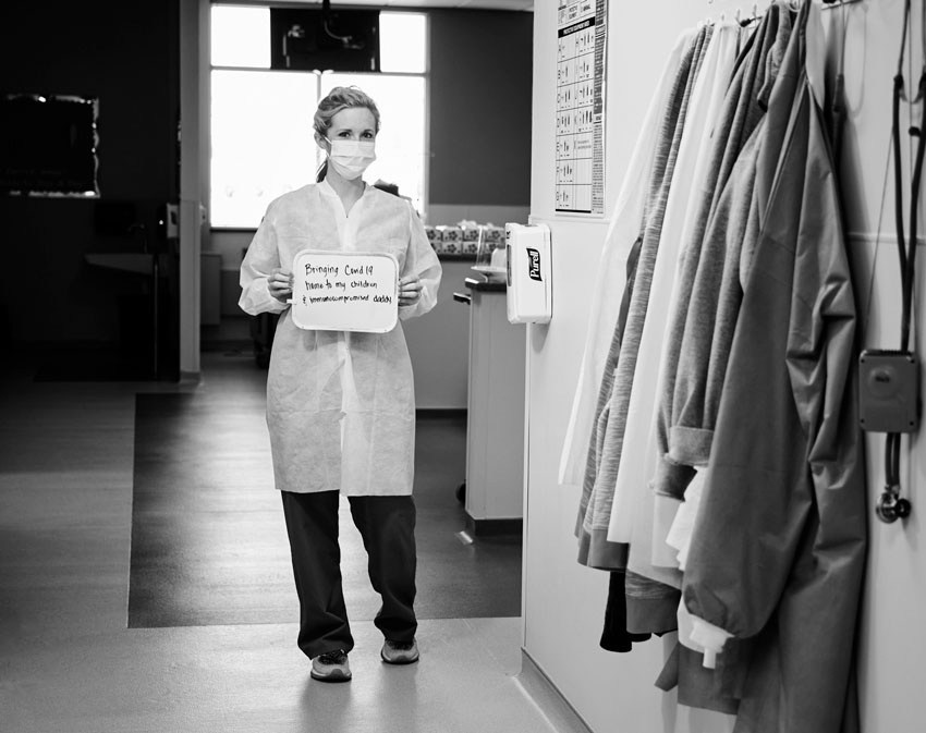 Jon Morgan's photo of another nurse in PPD, whose sign says she worries about bringing COVID-19 home to her high risk family