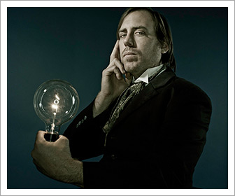 Photo of a man imitating Nikola Tesla holding a light bulb by Los Angeles-based portraiture photographer Joseph Escamilla. 