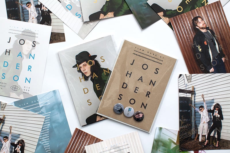 A photographer's promo collection shown alongside portrait postcards, buttons, and a personalized stamp 