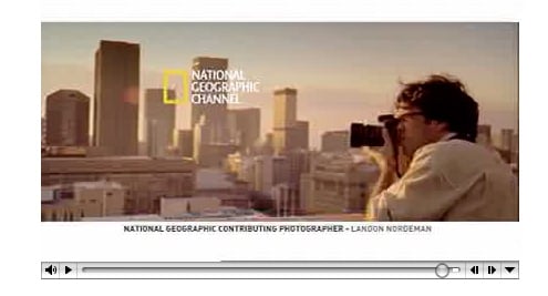 Still from National Geographic Channel TV ad showing Landon Nordeman taking a picture.