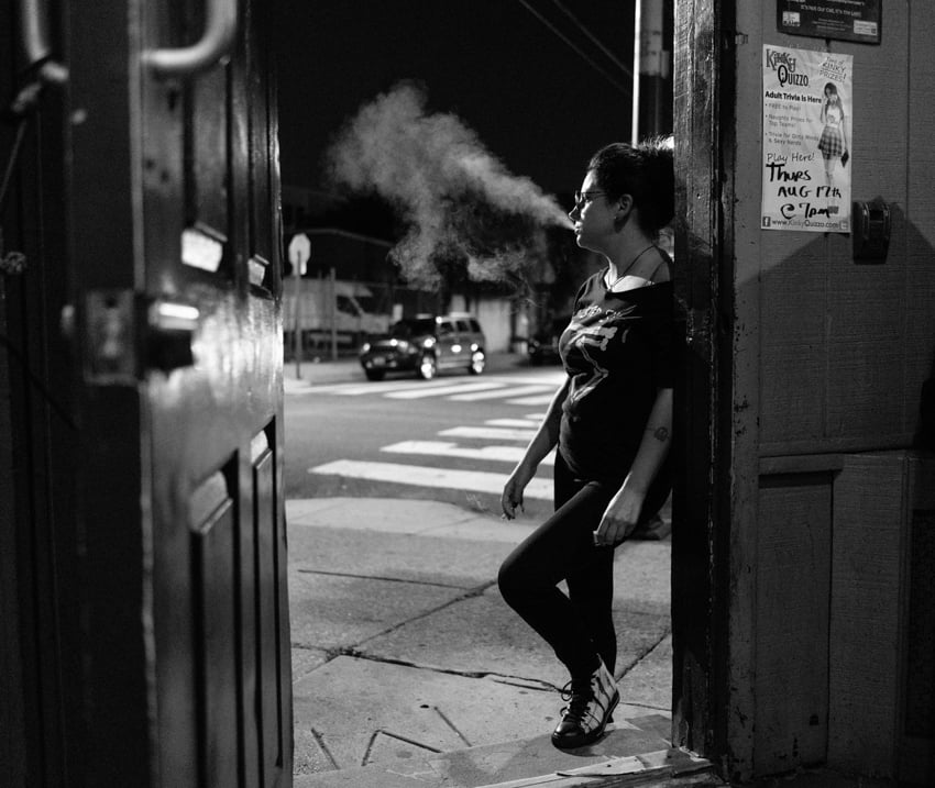 Patron smoking outside a Philadelphia dive bar by Gene Smirnov.