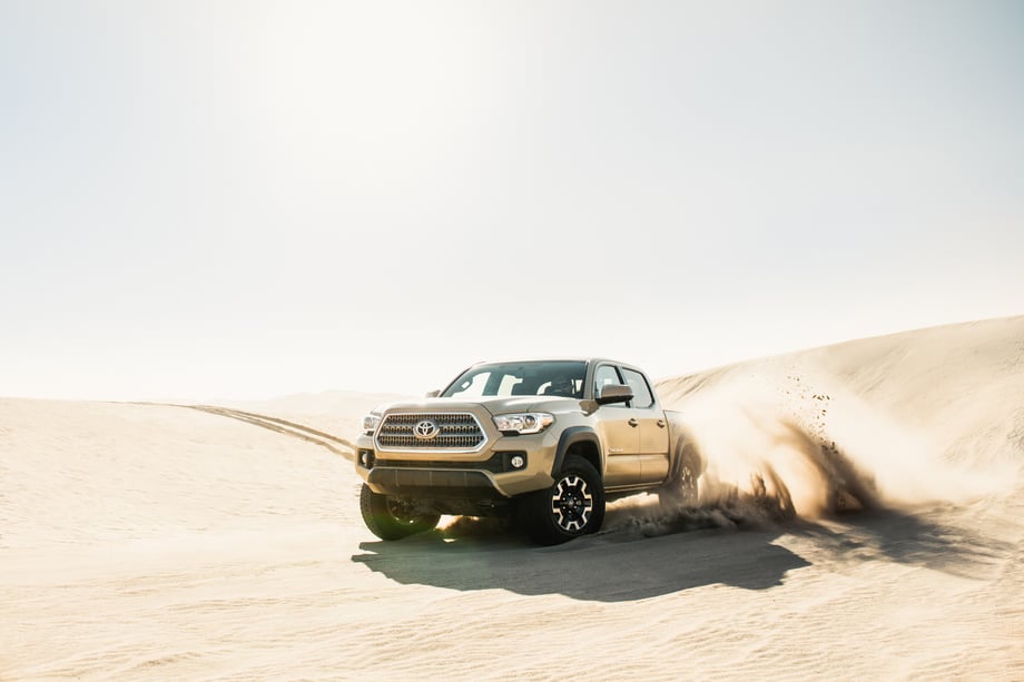 The Toyota Tacoma driving through the desert by Mark Skovorodko