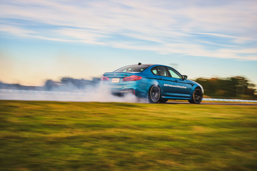 Mike D’Ambrosio shoots a blue BMW from behind as it speeds up on the Performance Driving Center raceway