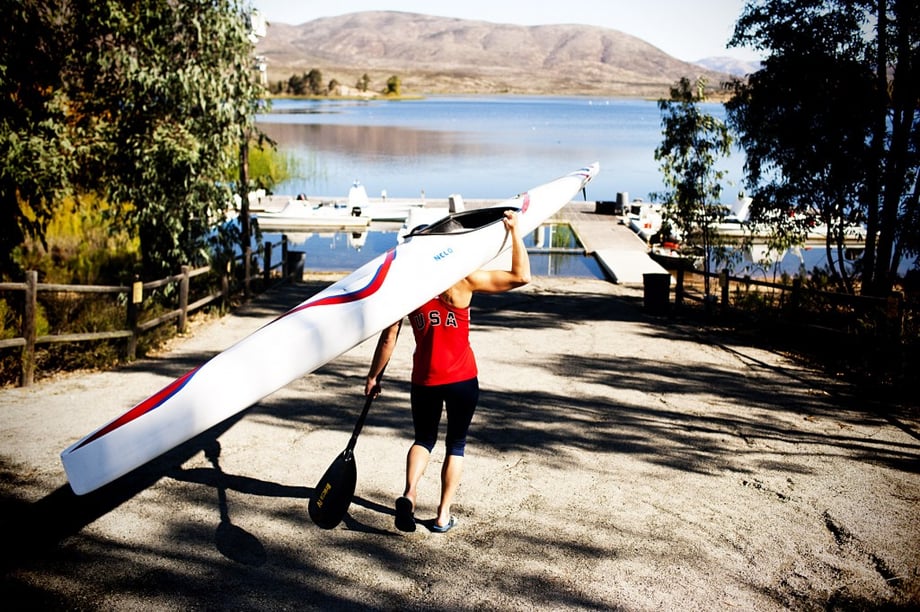 Olympian carrying canoe to lake