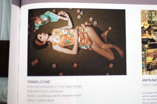 Photograph of a woman on the ground with a baby by Tamar Levine