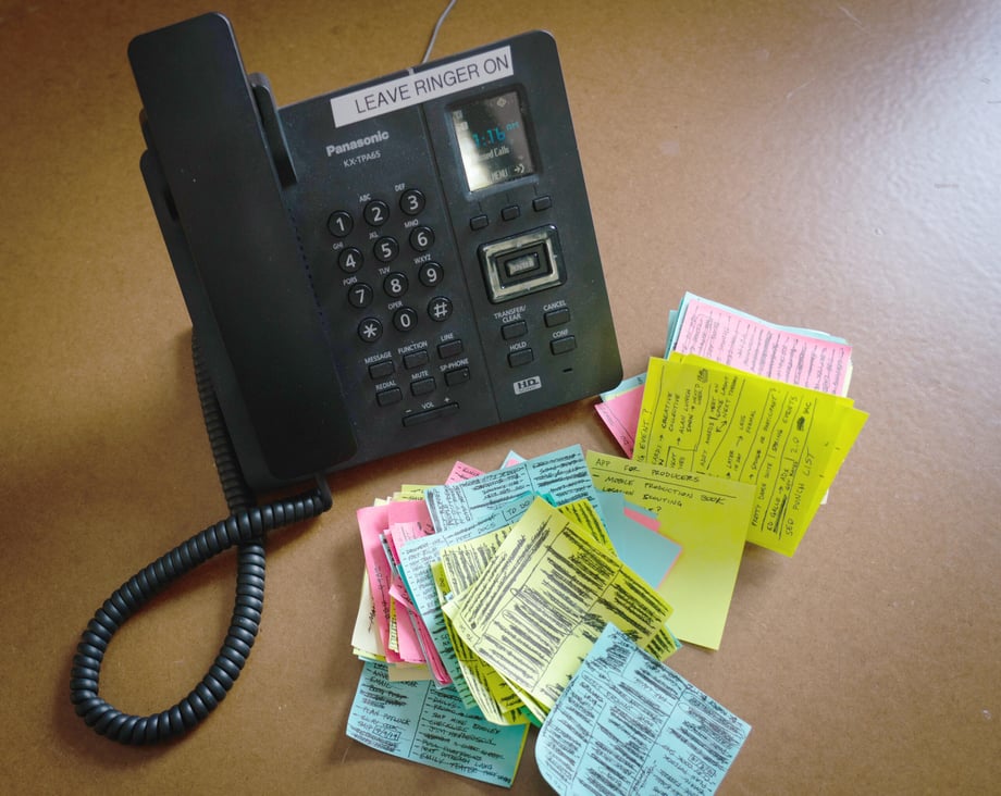 Photo of a phone and post-it notes.