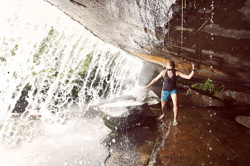 Woman under waterfall in Asheville, North Carolina