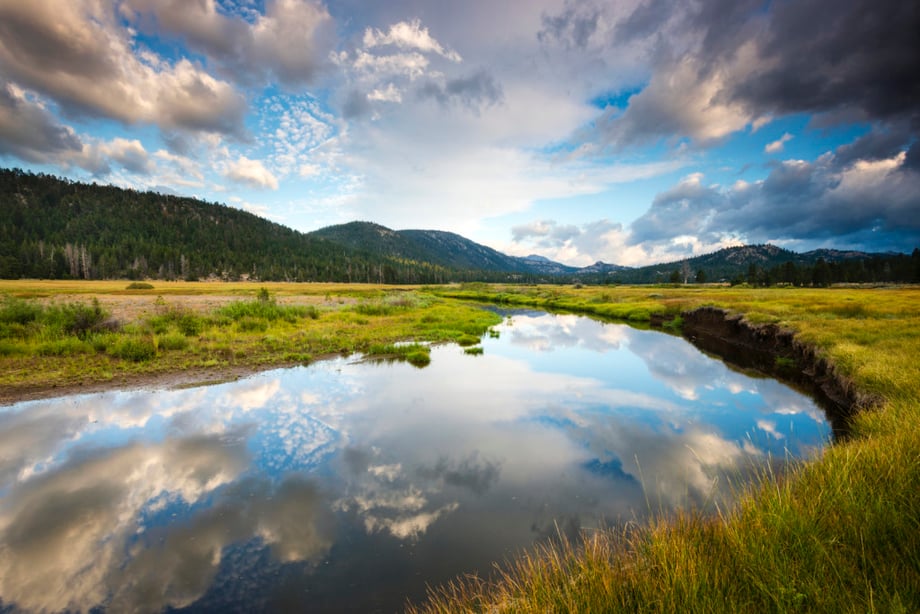 The still water of the West Fork of the Carson River reflects the beautiful clouds overhead in Hope Valley, California.