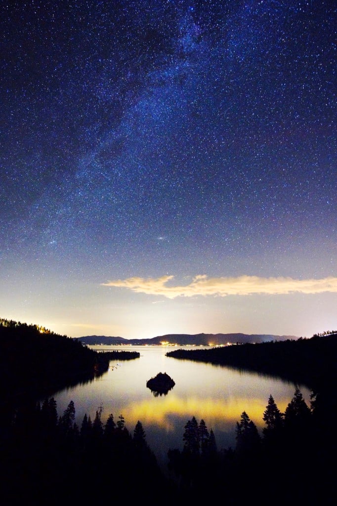 The Milky Way and stars over Emerald Bay at night in Lake Tahoe, CA.