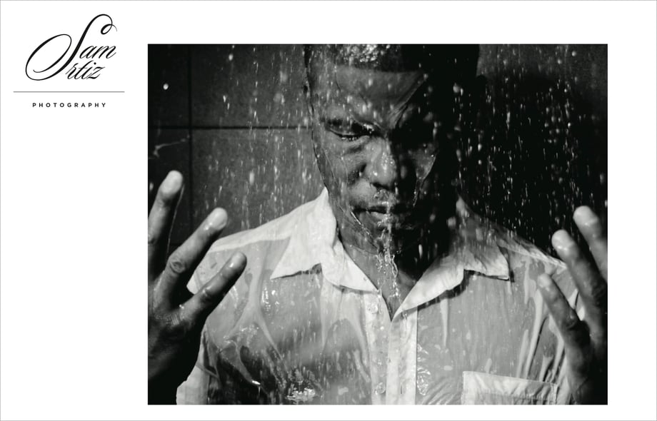 a possible logo show on Sam's website, alongside a portrait of a man in the shower