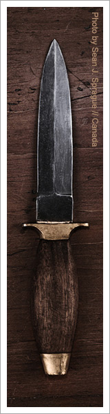 Still life of a knife with a wooden handl by sean. j. sprague