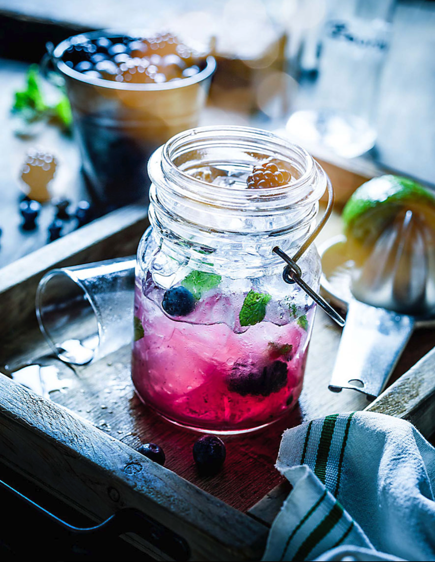 Teri Campbell shares a photo from a personal project of a glass jar filled with berries, juice, ice, and mint