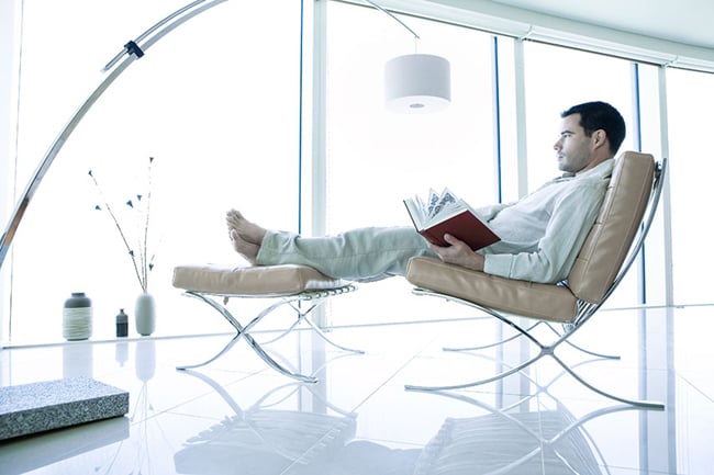 Photograph by Toufic Araman of a man lounging in a very modern looking space
