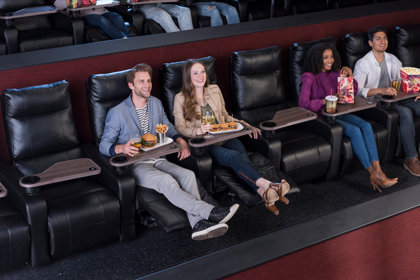 Photo for Cinemark of a couple having a meal and drinks in luxury loungers.