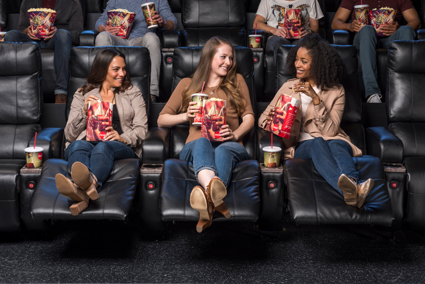 Photo by Wade Griffith for Cinemark of moviegoers enjoying popcorn and sodas and luxury loungers.