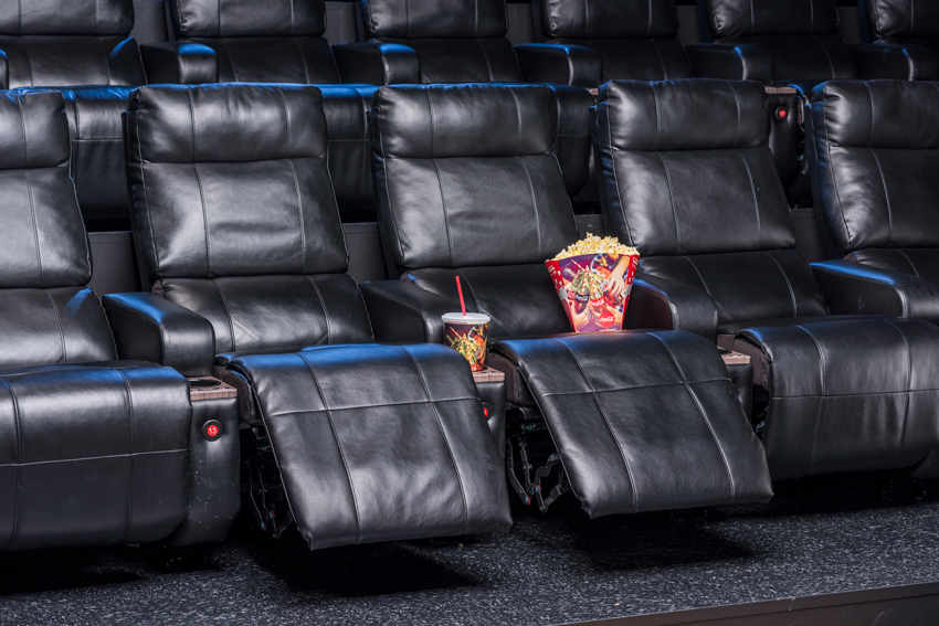 Photo for Cinemark of empty luxury loungers with popcorn and sodas.