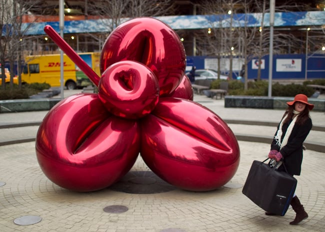 Woman next to balloon statue