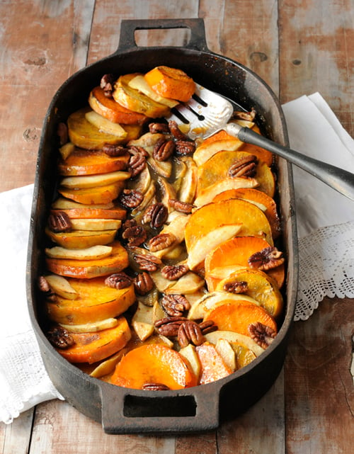 A baking dish full of peaches and pecans