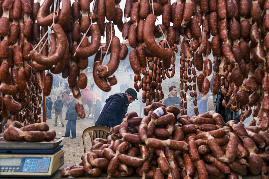 Camel meat sausages for sale from stalls surrounding the wrestling arena shot by Bradley Secker featured in the New York Times