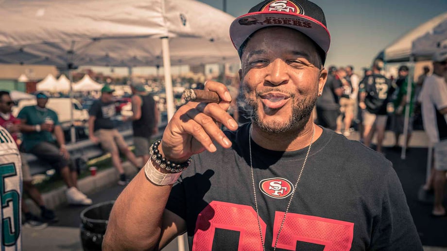 Eagles fan smoking cigar at Lincoln Financial Field tailgate shot by Zave Smith for Metro Philadelphia