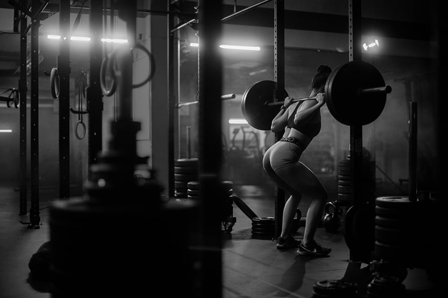 Carrie Xu at a gym lifting weights. Photographed by Albert Law. 