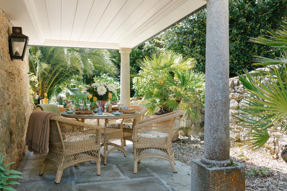 A set table on the sunlit terrace outside of Robert Carslaws Cornwall home shot by Anya Rice for Home & Garden magazine