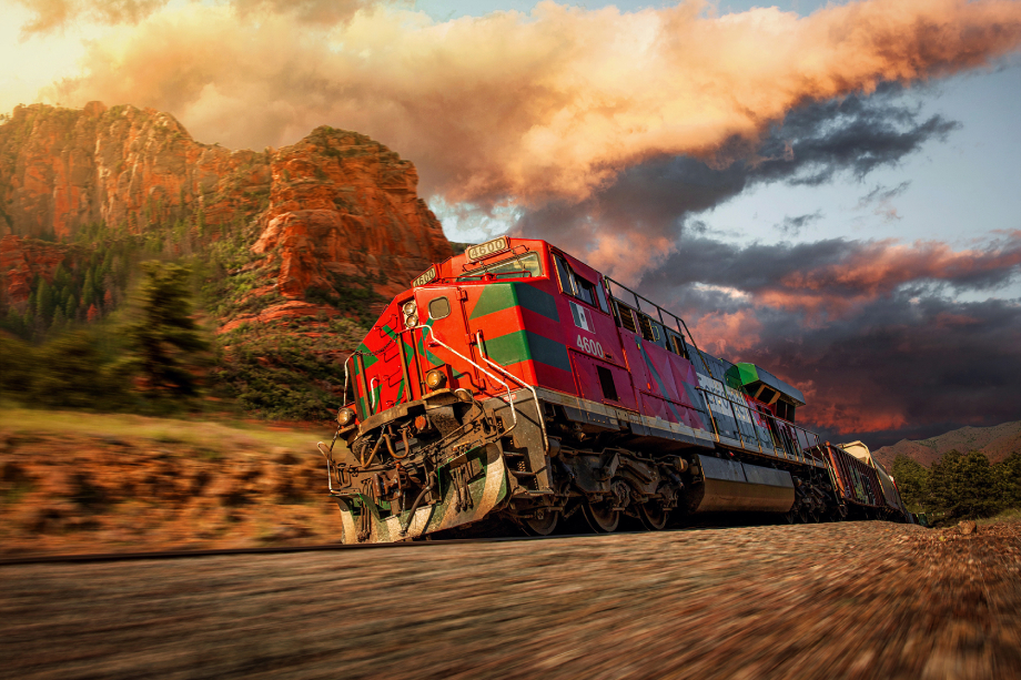 Freight train passing desert Arizona landscape at sunset shot by Blair Bunting