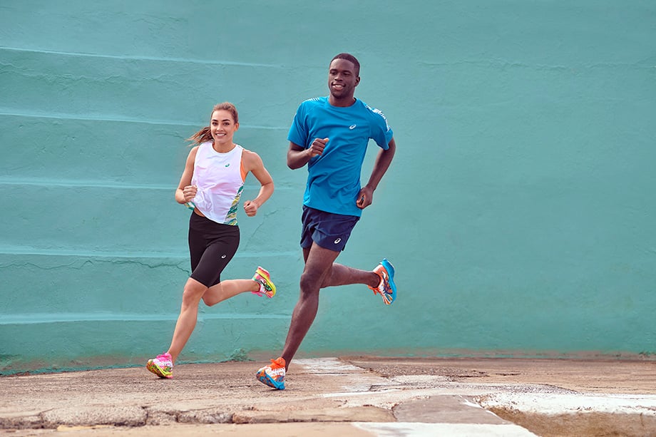 Two runners against a bright blue wall for Asics photographed by Brett Hemmings