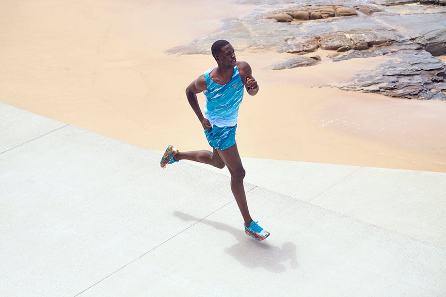 Brett Hemmings photographs a runner sprinting across the pavement next to a sand beach for Asics