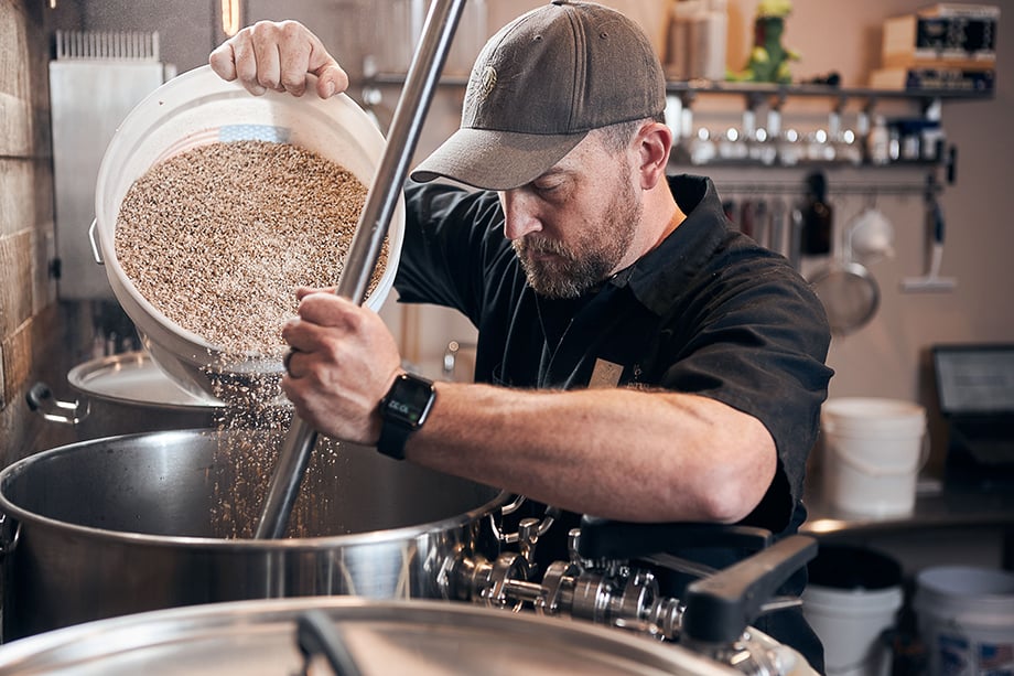 A brewer prepares a batch. Photographed by CJ Foeckler for Spike Brewing. 