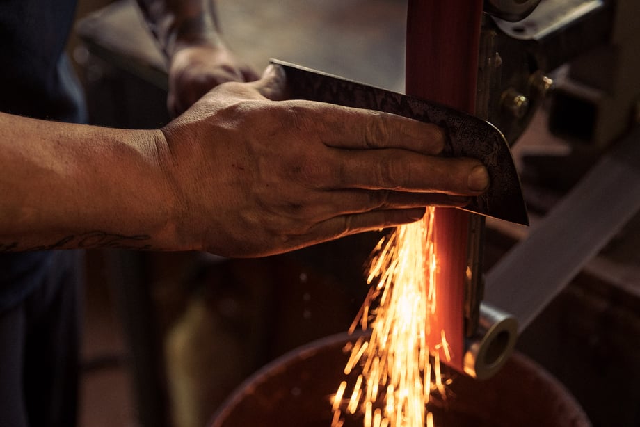 Sparks fly in metal workshop shot by Christian Tisdale for Makers series
