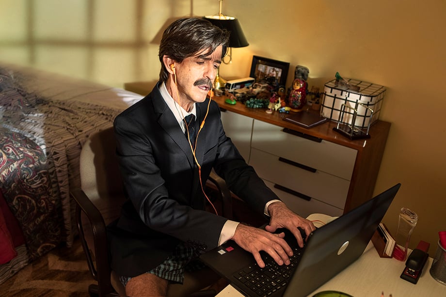 Image of man listening to music and typing on his computer while at work in his underpants. Photographed by Claus Lehmann for Spotify Brazil. 