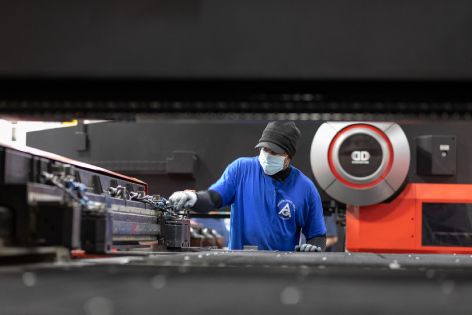 Sheet metal worker using Amada laser cutting technology shot by Dan Bigelow